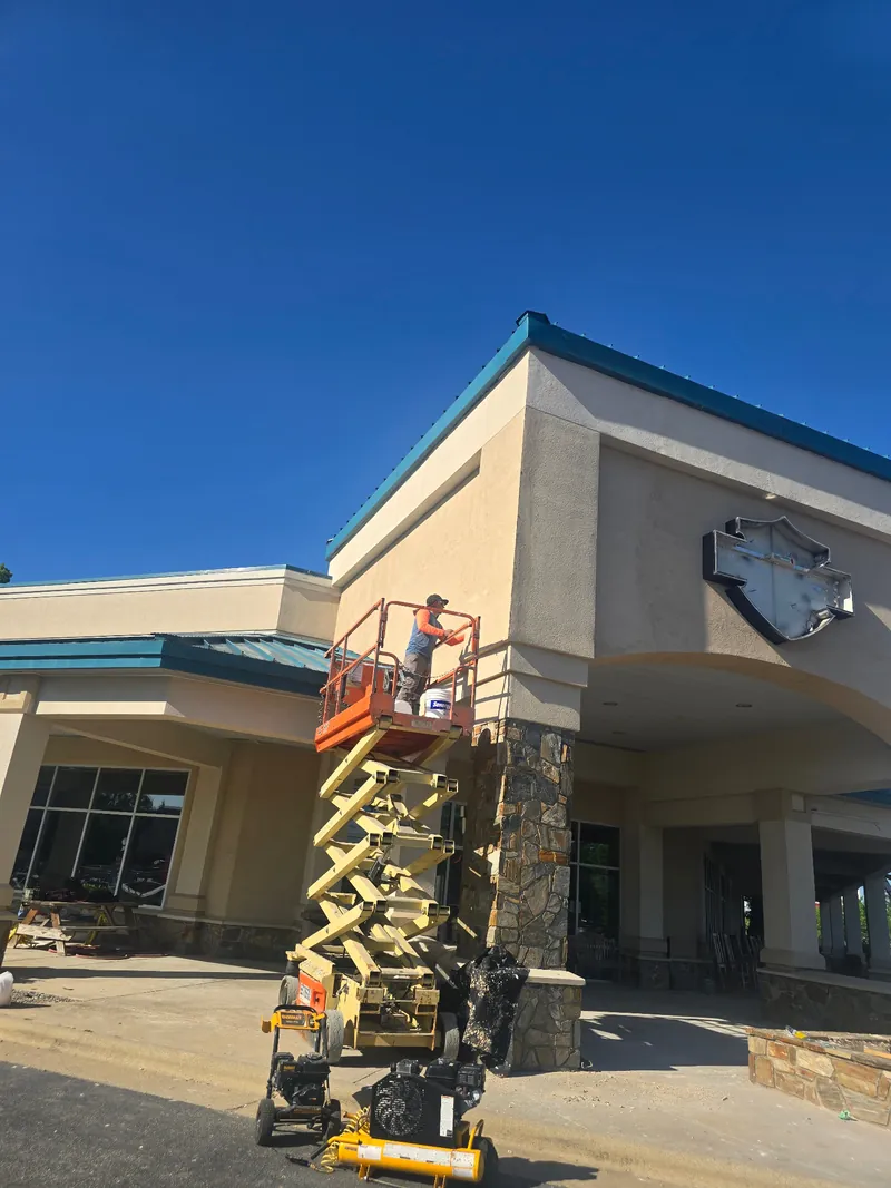 Applying stucco finish to facade